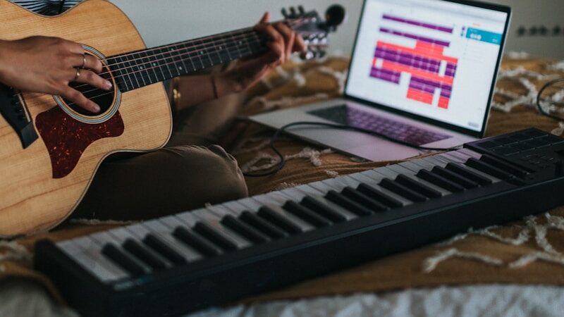 woman playing brown acoustic guitar